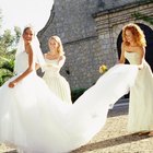 Bride holding bouquet beside groom