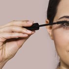 Woman applying false eyelashes