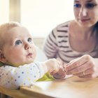 a newborn baby sucking a nursing bottle