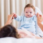 Charming mother feeding her adorable son in the kitchen