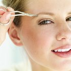 Woman plucking her eyebrows