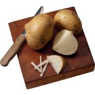 White potatoes in a bowl on a wood table top