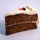 Young man putting cherry on top of cake, close-up