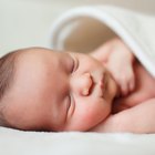 Smiling baby girl lying on a bed