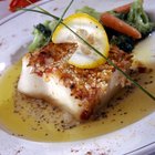 Close-up of a cod fillet with rosemary on a plate