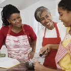 Mother and Her Young Daughter Stand in the Kitchen Eating Cheese Sandwiches for Lunch