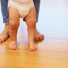 Newborn baby girl sleeping on bouncer chair in dark room