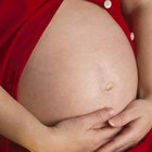 Smiling Pregnant Woman Lying on Sofa