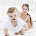 Woman looking down at baby sleeping