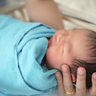 Infant sleeping on a bed