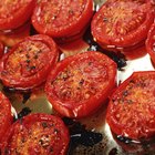 Whole canned tomatoes in brown bowl on wood.