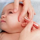 sleeping baby in hand of mother