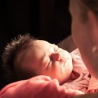 Newborn baby lying on a white background