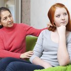 Hispanic mother helping daughter with homework