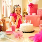 Girl (9-11) at birthday party, leaning over birthday cake, portrait