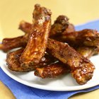 Classic BBQ ribs on parchment paper with BBQ sauce