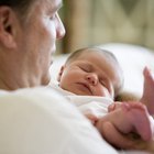 Newborn wrapped in white blanket