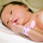 Newborn baby boy under a blue blanket