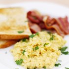 Scrambled eggs on Pan with grilled toast.