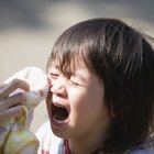 Boy holding missing teeth