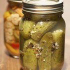 marinated cornichons in wooden bowl