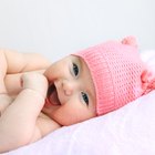 Measuring smiling beautiful comfortable little baby