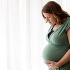 Beautiful pregnant woman drinking water