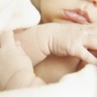 Cute baby boy in a white crib