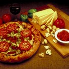 Chef making pizza on table, elevated view