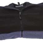 Black polyester twill fabric texture background, open jacket zipper closeup
