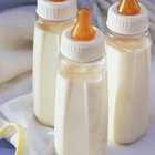 Three bottles of milk on top of blanket or bib