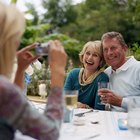 Close-up of romantic senior couple holding wineglasses on the beach