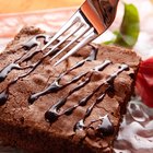 chocolate brownie diced baking paper on wooden table with a