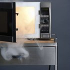 Stainless steel microwave oven on white
