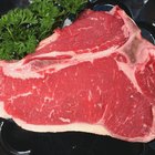 Female chef garnishing a plate with steak