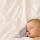 Newborn Baby Girl Sleeping in Bowl