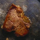 Closeup meat steel pan with spices ready to cook table