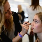Teenage girls applying makeup