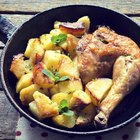 Easy fried chicken pieces in a serving dish with lemon wedges