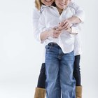 Young woman sitting on a table with a young man sitting on a couch behind her