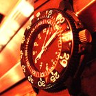 Mid adult man standing at street, looking at watch