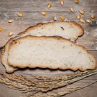 Homemade bread with spikelet of wheat on cloth on boards