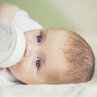 Mother feeding baby boy, portrait, side view