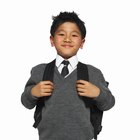 young girl with backpack looking over shoulder