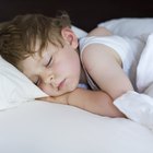 Hands of mother caressing her baby girl sleeping