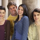 Portrait of a female graduate standing with a mid adult man and a young woman