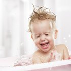 Creaming face of infant girl after bath