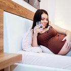 Pregnant young woman looking at her belly