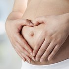 Pregnant woman holding belly in pharmacy