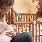 Mother changing baby diaper